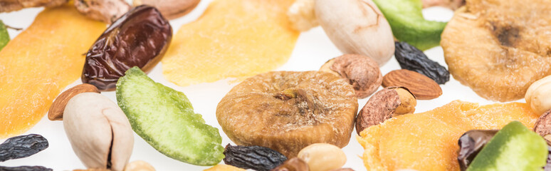 close up view of Turkish assorted nuts, dried fruits and candied fruit isolated on white, panoramic shot