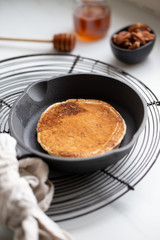 Pancakes with banana, walnuts and honey. Morning concept
