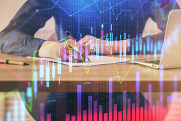 Double exposure hands with stock market chart.