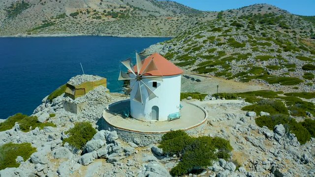 fly around the mill on island of Simi, panormitis monastery, beautiful Bay and a large ship at pier. Greece