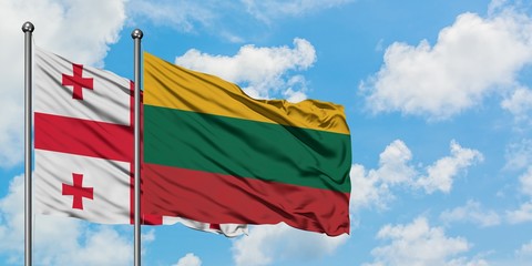 Georgia and Lithuania flag waving in the wind against white cloudy blue sky together. Diplomacy concept, international relations.