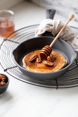 Pancakes with banana, walnuts and honey. Morning concept