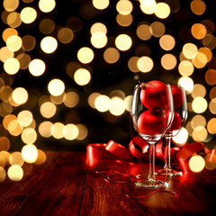 Christmas wooden table of free space for your decoration.Bokey dark background.Glasses on top with christmas balls.Copy space,New Year time,Christms Eve,Coffee table and place for your decoration.
