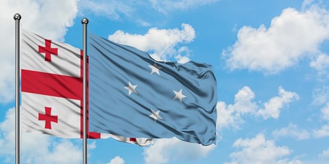 Georgia and Micronesia flag waving in the wind against white cloudy blue sky together. Diplomacy concept, international relations.