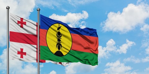 Georgia and New Caledonia flag waving in the wind against white cloudy blue sky together. Diplomacy concept, international relations.
