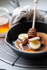 Pancakes with banana, walnuts and honey. Morning concept