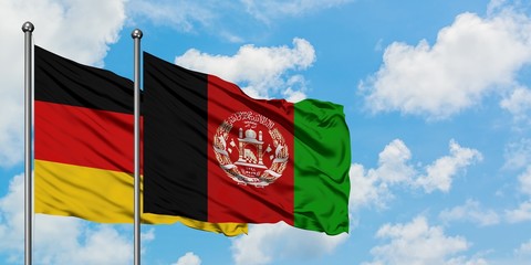 Germany and Afghanistan flag waving in the wind against white cloudy blue sky together. Diplomacy concept, international relations.