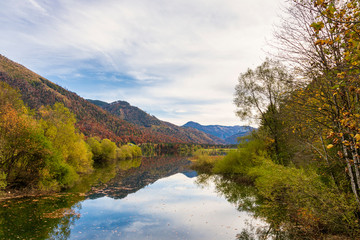 Fototapeta na wymiar Autumn forest lake reflection landscape in Austria