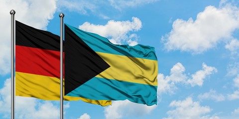 Germany and Bahamas flag waving in the wind against white cloudy blue sky together. Diplomacy concept, international relations.