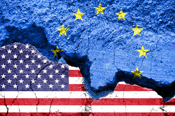 US American and european flags on cracked background. Concept of  diplomatic crisis, tariffs and...