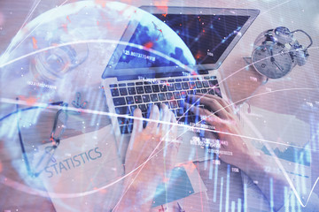 Fototapeta na wymiar Multi exposure of forex graph with man working on computer on background. Concept of market analysis.