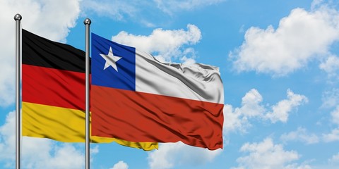 Germany and Chile flag waving in the wind against white cloudy blue sky together. Diplomacy concept, international relations.