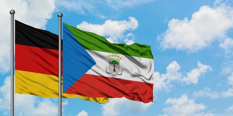 Germany and Equatorial Guinea flag waving in the wind against white cloudy blue sky together. Diplomacy concept, international relations.