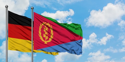 Germany and Eritrea flag waving in the wind against white cloudy blue sky together. Diplomacy concept, international relations.