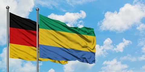 Germany and Gabon flag waving in the wind against white cloudy blue sky together. Diplomacy concept, international relations.