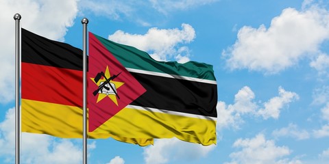 Germany and Mozambique flag waving in the wind against white cloudy blue sky together. Diplomacy concept, international relations.