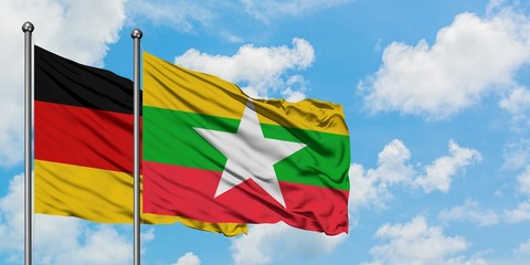 Germany and Myanmar flag waving in the wind against white cloudy blue sky together. Diplomacy concept, international relations.