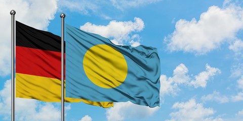 Germany and Palau flag waving in the wind against white cloudy blue sky together. Diplomacy concept, international relations.