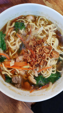 Traditional Indonesian meal soup noodle with vegetables and chicken