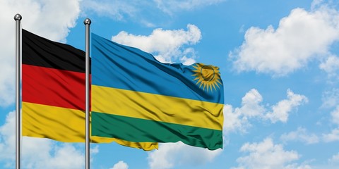 Germany and Rwanda flag waving in the wind against white cloudy blue sky together. Diplomacy concept, international relations.