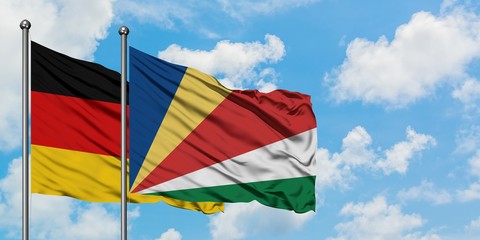 Germany and Seychelles flag waving in the wind against white cloudy blue sky together. Diplomacy concept, international relations.