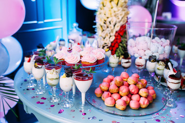 Beautifully decorated table with different cakes and sweets