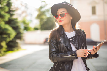 Obraz premium Young asian woman uses smart phone on the street