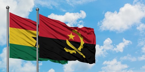 Ghana and Angola flag waving in the wind against white cloudy blue sky together. Diplomacy concept, international relations.