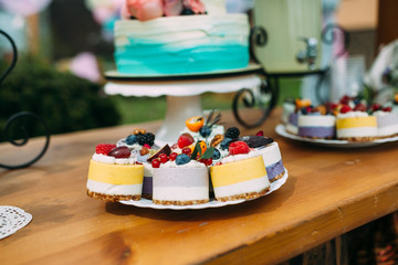 Cake with berries and fruits on a festively decorated table