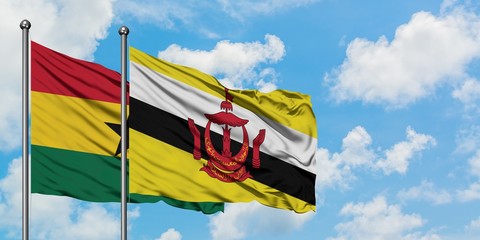 Ghana and Brunei flag waving in the wind against white cloudy blue sky together. Diplomacy concept, international relations.