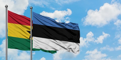 Ghana and Estonia flag waving in the wind against white cloudy blue sky together. Diplomacy concept, international relations.