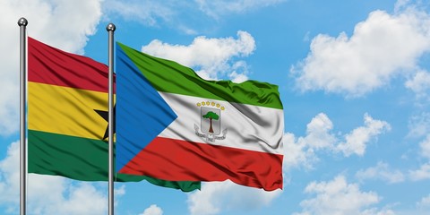 Ghana and Equatorial Guinea flag waving in the wind against white cloudy blue sky together. Diplomacy concept, international relations.