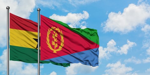 Ghana and Eritrea flag waving in the wind against white cloudy blue sky together. Diplomacy concept, international relations.