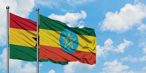 Ghana and Ethiopia flag waving in the wind against white cloudy blue sky together. Diplomacy concept, international relations.