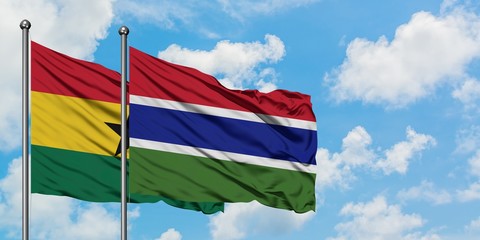 Ghana and Gambia flag waving in the wind against white cloudy blue sky together. Diplomacy concept, international relations.