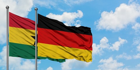 Ghana and Germany flag waving in the wind against white cloudy blue sky together. Diplomacy concept, international relations.