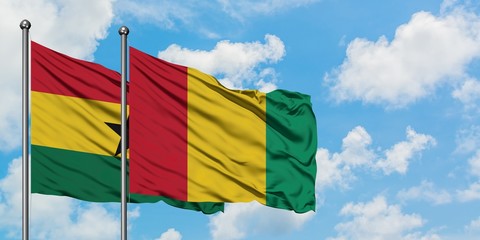 Ghana and Guinea flag waving in the wind against white cloudy blue sky together. Diplomacy concept, international relations.