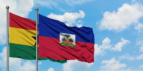 Ghana and Haiti flag waving in the wind against white cloudy blue sky together. Diplomacy concept, international relations.