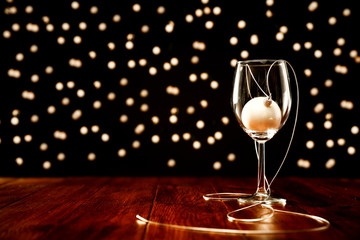 Dark wooden mood table of free space for your decoration.Chrsitmas glass with xmas balls.Blurred dark background of bokey.Winter cold night and Christmas Eve. Empty place for your gifts. Copy space. 