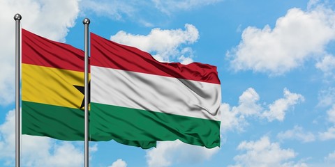 Ghana and Hungary flag waving in the wind against white cloudy blue sky together. Diplomacy concept, international relations.