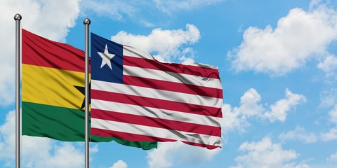 Ghana and Liberia flag waving in the wind against white cloudy blue sky together. Diplomacy concept, international relations.