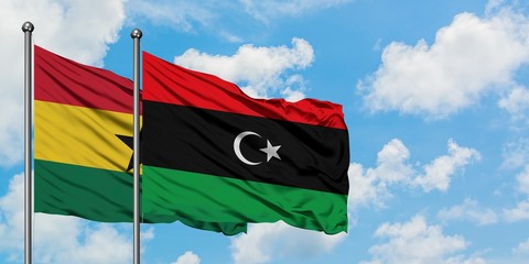 Ghana and Libya flag waving in the wind against white cloudy blue sky together. Diplomacy concept, international relations.