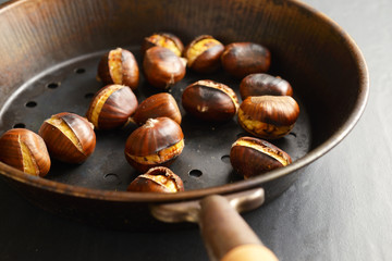 roasted chestnuts on a perforated pan