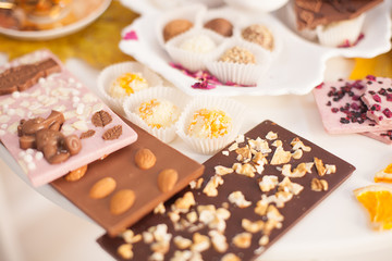 a Cup of tea on the table with desserts. an abundance of sweets and delicious handmade sweets. celebration and tea party. The view from the top, Flatley. chocolate with nuts and marzipans