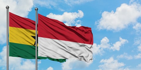 Ghana and Monaco flag waving in the wind against white cloudy blue sky together. Diplomacy concept, international relations.
