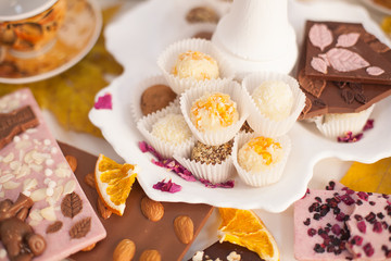 a Cup of tea on the table with desserts. an abundance of sweets and delicious handmade sweets. celebration and tea party. The view from the top, Flatley. chocolate with nuts and marzipans