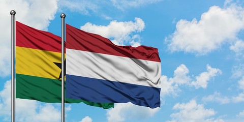 Ghana and Netherlands flag waving in the wind against white cloudy blue sky together. Diplomacy concept, international relations.