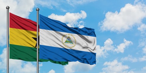 Ghana and Nicaragua flag waving in the wind against white cloudy blue sky together. Diplomacy concept, international relations.