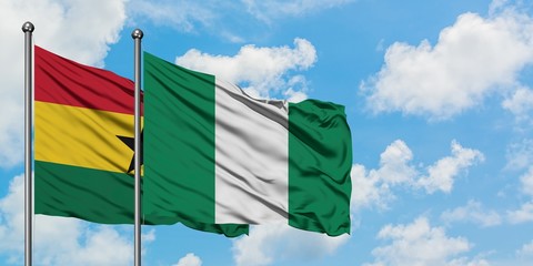 Ghana and Nigeria flag waving in the wind against white cloudy blue sky together. Diplomacy concept, international relations.