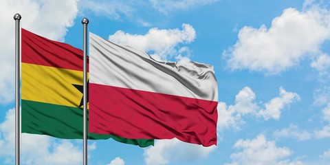 Ghana and Poland flag waving in the wind against white cloudy blue sky together. Diplomacy concept, international relations.
